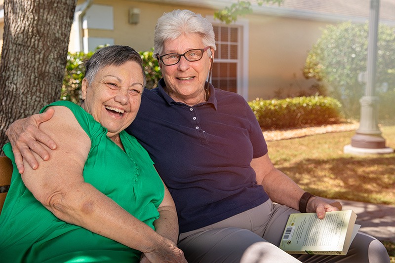 assisted living residents reading outside